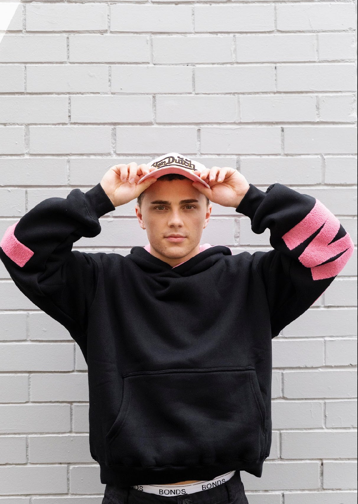 Mooody unisex hoodie black and pink front view