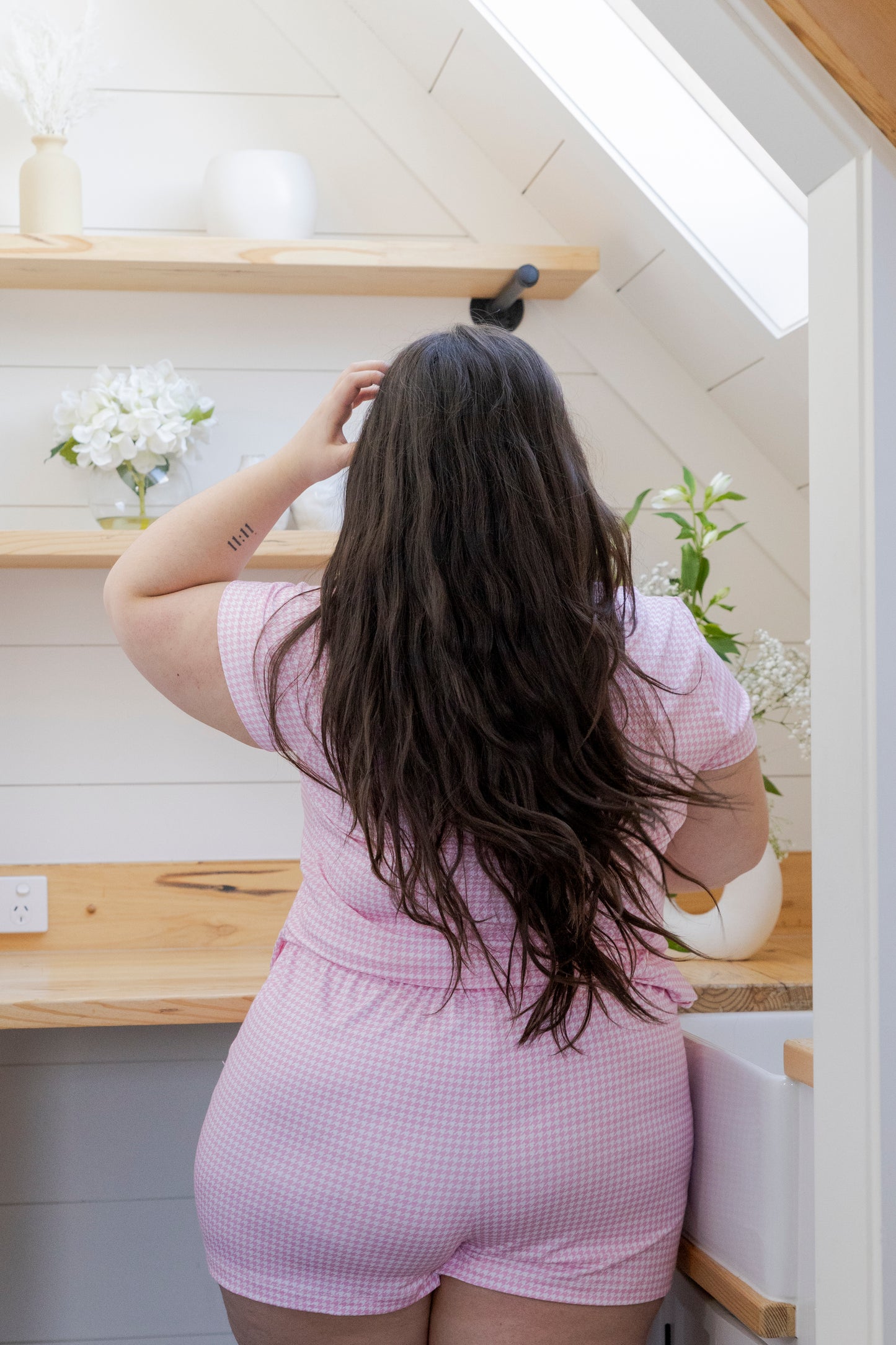 Women wearing Mooody bamboo loose fitted pyjama shirts in pink and white houndstooth matching set